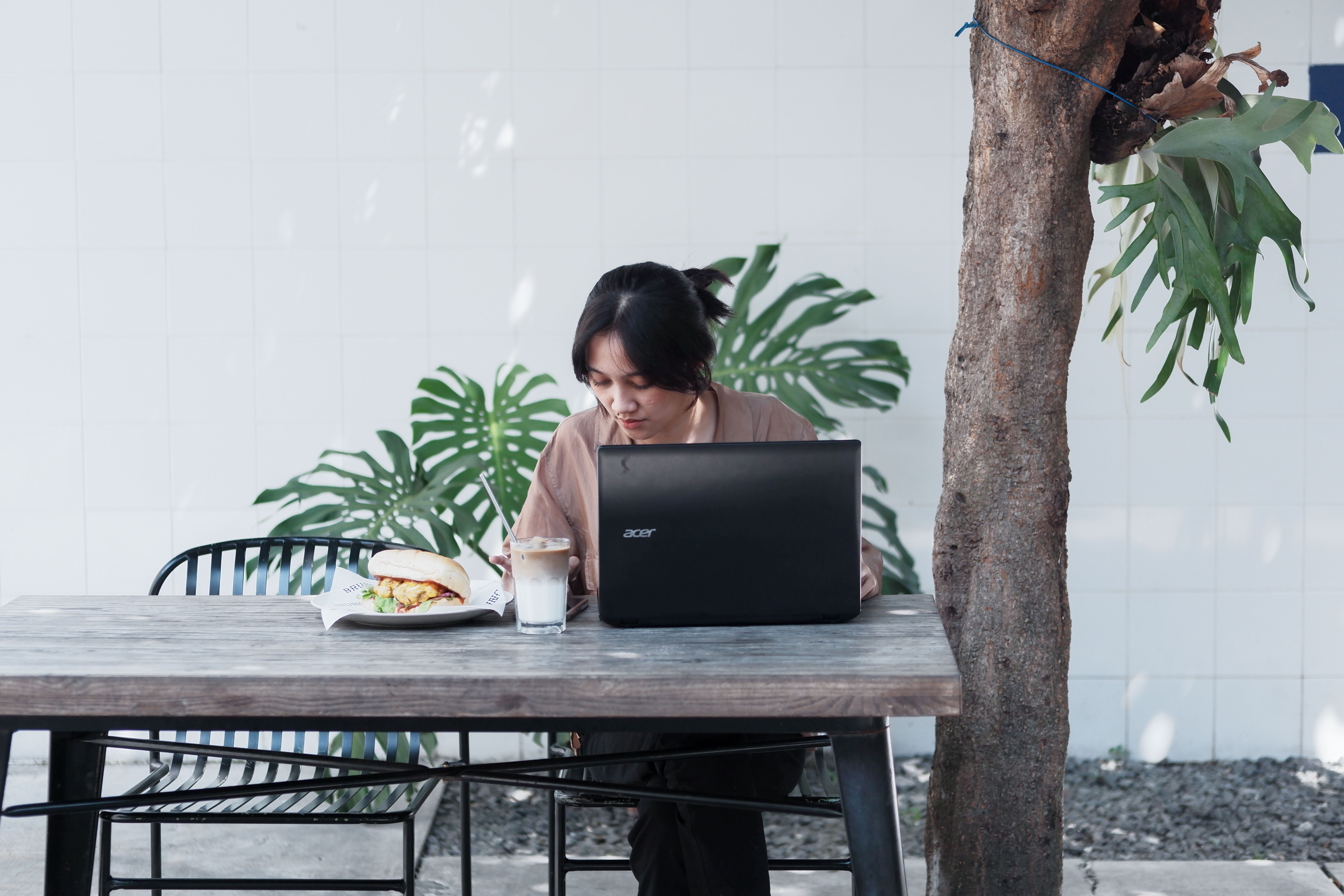Orang bekerja menggunakan laptop di cafe