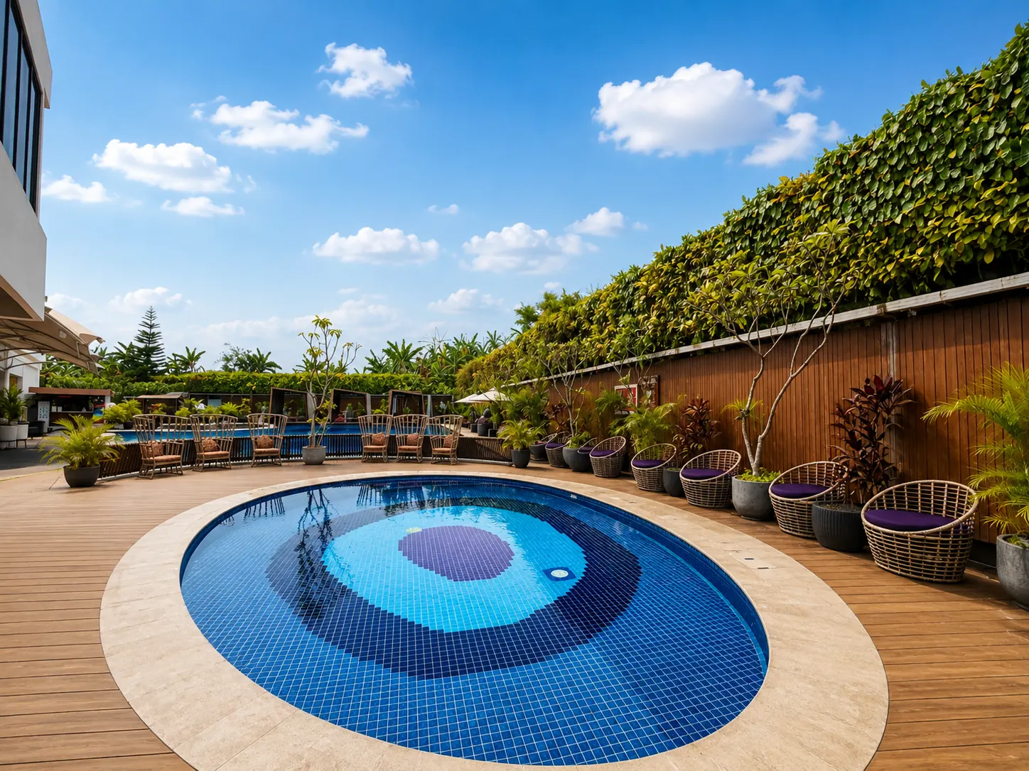 Kolam oval berdek kayu di The Alana Hotel Sentul City dengan kolam utama di belakang