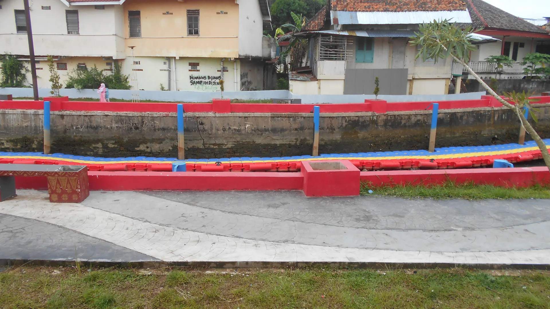 Jalur pedestrian berpagar merah di tepi Sungai Sekanak, Bukit Kecil, Palembang